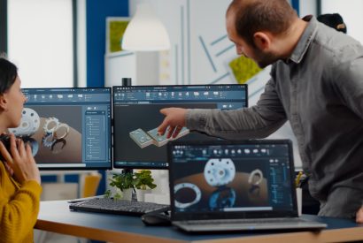 Industrial development engineer analysing and sharing ideas with project manager working on computer. Team of professionals using CAD Software for modern industrial engineering design.